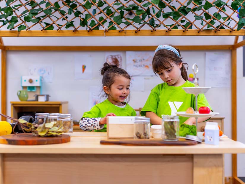 Two children standing at counter