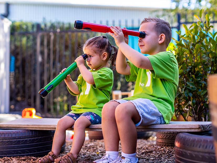 Kids looking through telescopes