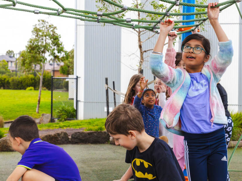 Kids playing on climbing rope at outside school hours care